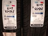 two tires on a shelf with price tags on them