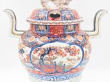 a large vase with a bird on top of it