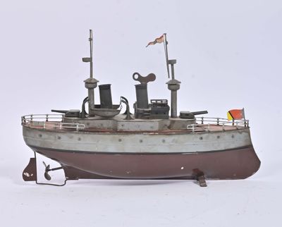 a small model of a boat on a white surface