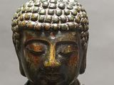 statue of a person with a hat on his head and eyes closed