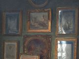 a painting on the wall of a room with pictures on the wall