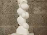 a white sculpture sitting on top of a wooden table