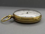 a gold pocket watch with a chain hanging from it