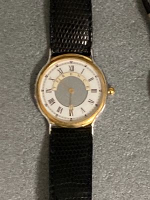 a watch that is sitting on a table next to a watch