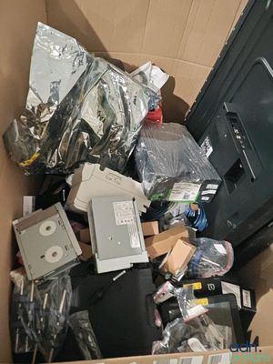 a cardboard box full of electronics and other items