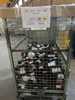 a metal cart with many bottles of wine in it