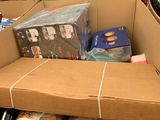 a cardboard box full of cds and cds in a store