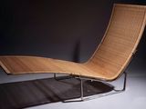 an image of a modern lounge chair in a dark room