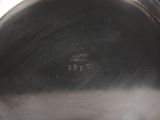 an antique silver plate with a silver lid and a black background