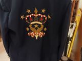 navy blue jacket with gold stars and a crown on the back