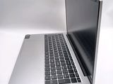 a silver laptop computer sitting on top of a white table