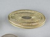 three different types of coins on a white surface with a coin in the foreground