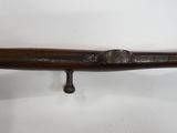 an old wooden baseball bat hanging on a wall