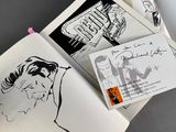 an open book with a drawing of a man and a woman on it