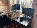 a desk with two monitors and a keyboard on it