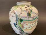 a white vase with a painting on it sitting on a table