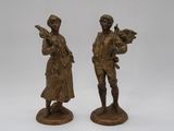 pair of antique bronze figurines of a man and a woman
