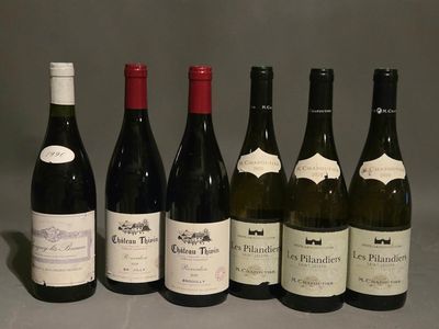 several bottles of wine are lined up on a table