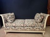 an upholstered daybed with a floral pattern on it in a room
