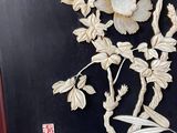 a picture of a wall hanging with a bird and flowers on it