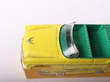 a yellow toy car that is sitting on top of a box