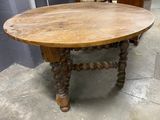 an old table with a wooden top and wooden legs
