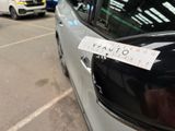 a sticker on the side of a car that is parked in a parking lot