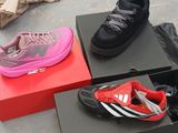 three pairs of shoes that are on display in a box