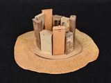 a small model of a castle on a black surface