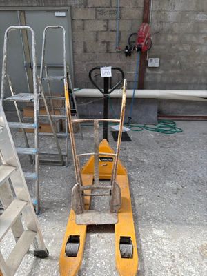 un chariot élévateur jaune équipé d'une échelle, dans un garage