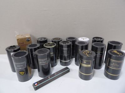many rolls of black wine sitting on a white table