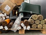 many rolls of fabric on a pallet in a warehouse