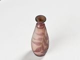 a small glass vase sitting on a white table