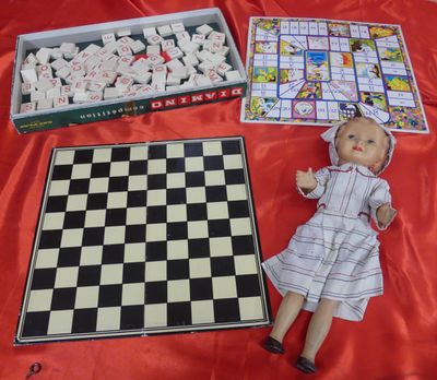 a doll that is sitting next to a chess board