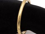 an image of a close up of a gold ring on a black napkin