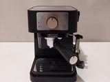 an image of a black coffee machine sitting on top of a white table
