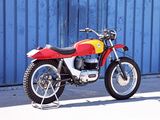 a red and yellow motorcycle parked in front of a blue wall