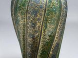 a green vase with a brown lid on a white background