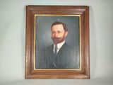 painting of a bearded man in a suit and tie in a wooden frame
