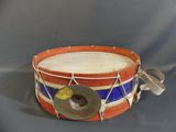 an old drum with a blue and red stripe on it
