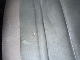 a small piece of fabric on the back seat of a car