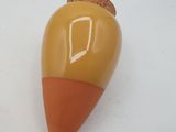 a small orange and yellow object on a white surface