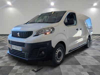 the white van is parked in a large room with a checkered floor