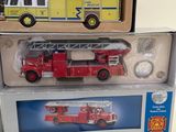 two boxed fire trucks sitting on top of each other on a table