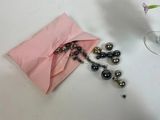 a glass of wine and a bead necklace on a table