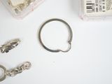 a pair of scissors, a ring, and some other items on a table