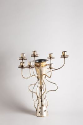 an image of a silver candelier with five candles on a white background