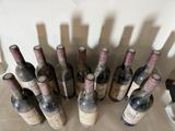 many bottles of wine that are sitting on a table