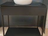 a black table with a white bowl on top of it