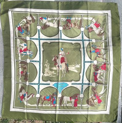green and white square scarf with a picture of a man riding a horse